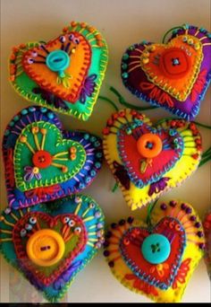 colorful heart shaped buttons are arranged on a table