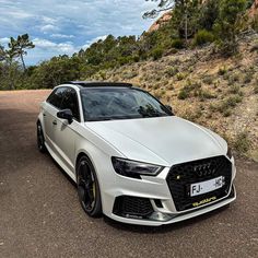 a white car parked on the side of a road