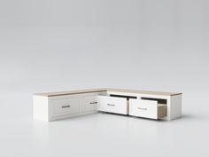 a white and wood desk with drawers on the bottom, in front of a gray background