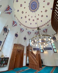 the inside of a large building with many windows and decorations on the ceiling, including a chandelier