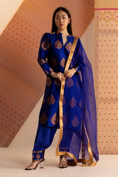 Royal blue mulberry silk kurta with detailing in kingkhap and all over butas in golden zari. Paired with salwar in satin with zari handwoven border. Paired with silk organza dupatta with golden zari border detailing.
Component: 3
Pattern: Handwoven
Type Of Work: Floral,zari
Neckline: Mandarin collar
Sleeve Type: Puff
Fabric: Mulberry Silk
Color: Blue
Other Details: 
Lining attached
Handwoven by artisans in Assam
Golden zari border on dupatta
Note: Natural variations in colour and weaves may occu Kurta For Women, Kurta Set For Women, Silk Kurta, Luxury Sale, Studio Blue, Organza Dupatta, Silk Organza, Kurta Set, Womens Tunics