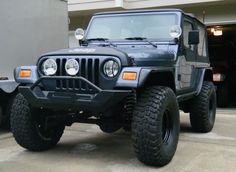 a black jeep parked in front of a building