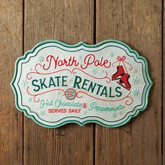 the north pole skate rental sign is mounted on a wooden wall