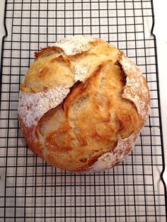 a loaf of bread sitting on top of a cooling rack