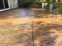 a concrete patio that has been cleaned and is being used as a planter area