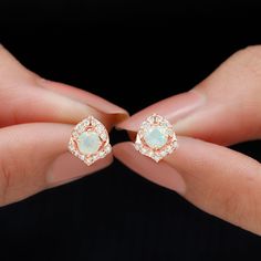 Product Details Sparkle in style with these beautiful Ethiopian opal stud earrings. Featuring a round-cut Ethiopian opal in the center of a petal motif, surrounded by sparkling Moissanite stones. These solid gold stud earrings are a must-have for April-born women. They are the perfect blend of sophistication and glamour, perfect for adding a touch of glam to any outfit. Give the gift of shine with these gorgeous opal studs, sure to make any woman feel special and loved. Product Information SKU S April Born, Beautiful Ethiopian, Opal Stud Earrings, Born In April, Opal Earrings Stud, Opal Studs, Gold Stud Earrings, Signature Jewelry, Timeless Jewelry