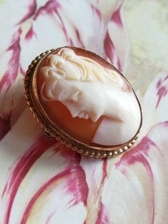 This is a vintage AMCO cameo brooch/pendant. It is oval and is stamped 1/20 14 K GF. The cameo measures just over .75 x a bit over 1 inch. Don't forget to stop in at my other Etsy shop... http://www.etsy.com/shop/xtdesigns. Follow me on Twitter at... MyYiayiaHadThat@MyYiayiaHadThat. If you have a wish list or are looking for something specific, please ask. I may have exactly what you are looking for. As always please convo me with any questions or concerns regarding this item or with any interna Vintage Oval Brooch With Cabochon, Vintage Oval Cabochon Brooch, Gold Oval Cameo Brooch, Vintage Oval Brooches For Wedding, Vintage Oval Wedding Brooches, Collectible Oval Cameo Brooch, Collectible Oval Cameo Brooches, Antique Gold Oval Brooch, Antique Gold Oval Brooches