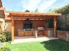 an outdoor kitchen with grill and barbecue area