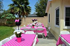 a minnie mouse themed birthday party with pink and white polka dot tablecloths, centerpieces and decorations