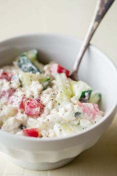 a white bowl filled with fruit salad on top of a table