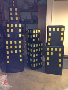 three cardboard blocks with yellow squares are sitting on the floor in front of a door