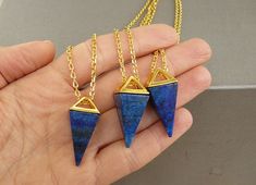 Lapis Lazuli Necklace Lapis Lazuli pendant Blue Necklace Pyramid Necklace Pyramid Pendant for women Necklace Blue Triangle Necklace This listing is for one necklace - Natural Lapis Lazuli pyramid pendant - 24K Gold-plated Brass Cross Chain Necklace Size of the pendant: about 15mm wide, 30~34mm long, 15mm thick LAPIS LAZULI: Keywords: Truth, Inner Power, Organization LAPIS LAZULI is a stone of communication that can bring truthfulness, openness, and mental clarity. It is used to help you say just Blue Long Necklace Suitable As A Gift, Blue Dangle Necklaces For Gifts, Cross Chain Necklace, Pyramid Necklace, Inner Power, Lapis Lazuli Pendant, Lapis Lazuli Necklace, Triangle Necklace, Cross Chain