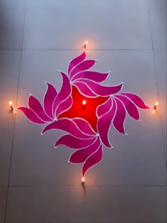 an artistic design on the floor with candles