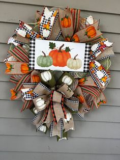 a wreath with pumpkins and gourds on it