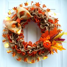 a wreath with orange and yellow leaves on it