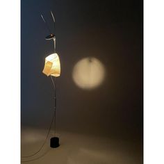 a lamp that is sitting on top of a table next to a light bulb in the dark