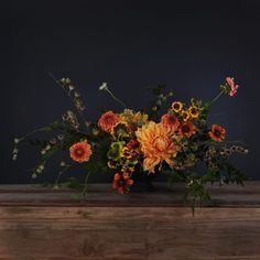 a vase filled with lots of different colored flowers