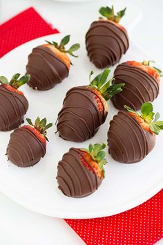 chocolate covered strawberries are arranged on a white plate