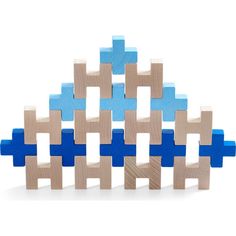 several wooden blocks are arranged in the shape of an abstractly designed structure with blue and beige squares