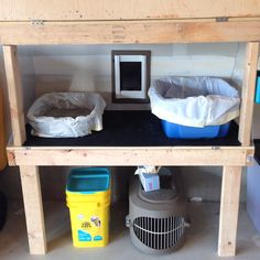 two bins are sitting on top of a shelf with plastic bags and trash cans