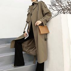 Look sharp and stay dry in this army green asymmetric trench coat! Featuring shoulder epaulets and a trendy belted waist, you'll be the chicest one around town even in the rainiest of days. Button up the gun flap for extra coverage, and voilà – you're ready for a stylish adventure! Long sleeves Spread collar with button belt Button gun flap Belted cuffs Front welt pockets Removable tie belt Lined Cotton, polyester Machine wash, tumble dry Item #310265 SIZE INFO XS=US2=UK6=EU32 S=US4-6=UK8-10=EU3 Casual Winter Outerwear With Belt, Khaki Belted Long Coat, Trendy Belted Outerwear For Winter, Khaki Belted Double-breasted Outerwear, Spring Outerwear With Belt, Double-breasted Belted Fall Outerwear, Fall Double-breasted Outerwear With Belt, Khaki Belted Utility Outerwear, Fall Double-breasted Belted Outerwear