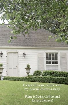 a white house with some plants in front of it and the words forget this one earlier with my neutral shutters story