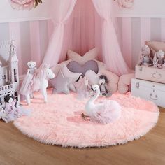 a pink bedroom with stuffed animals and toys