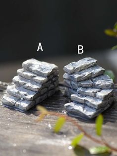 three pieces of rock sitting on top of a wooden table