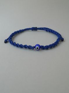 Blue evil eye Royal blue macrame bracelet Greek eye, round glass bead Materials used: 1mm waxed polyester string Sphere eye glass bead Other evil eye bracelets from my shop: https://www.etsy.com/shop/LuckyRatJewellery?section_id=14785936&ref=shopsection_leftnav_5 *Colours may differ slightly from the original due to the configuration of your computer. *There may be light variations on colour and size. *Items appear larger on your monitor than actual size. *Please take the time to read the po Adjustable Evil Eye Friendship Bracelets For The Beach, Blue Macrame Jewelry With Round Beads, Blue Spiritual Bracelet With Adjustable Cord, Adjustable Blue Macrame Jewelry, Blue Macrame Beaded Bracelets As A Gift, Spiritual Blue Bracelets With Adjustable Cord, Spiritual Blue Bracelet With Adjustable Cord, Blue Spiritual Friendship Bracelet With Sliding Knot, Blue Evil Eye Bracelet With Sliding Knot As Gift