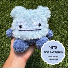 a hand holding a blue stuffed animal in the grass with text overlay that reads yeti pattern involves sewing