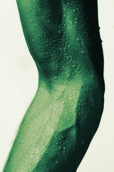 a man's torso covered in water droplets