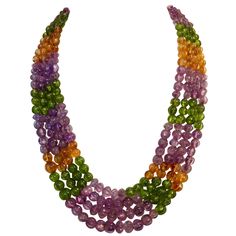 Four strands of graduated and "melon carved" beads in amethyst, peridot and citrine comprise this Mogul style necklace. The beads are graduated in size from 6mm to 10mm. They are strung on fine steel cable for safety. The necklace is completed with a 14k yellow gold clasp. PLEASE NOTE: This item is on a final. substantial markdown. Further discounts will not be considered. Gold Tassel Necklace, Multi Strand Beaded Necklace, Faceted Bead Necklace, Tiered Necklace, Rose Gold Pearl, Pearl Necklace Vintage, Peridot Jewelry, Vintage Beads Necklace, Peridot Necklace