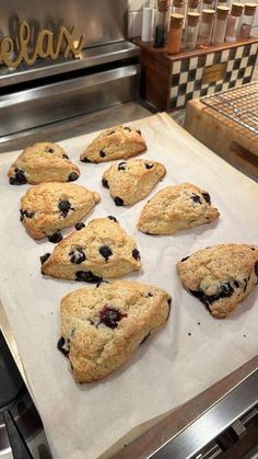 nine blueberry scones on a baking sheet in a kitchen with the word relax written above them