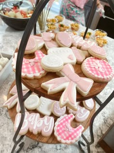 decorated cookies are displayed on a wooden platter