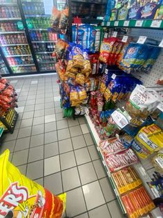 a grocery store filled with lots of different types of food and snacks on display in the aisles