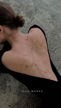 the back of a woman's body with lines drawn on her chest and shoulder