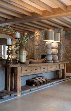 a living room filled with furniture and stone walls