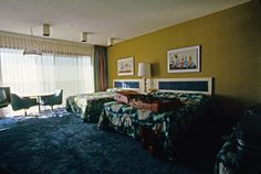 two beds in a hotel room with blue carpet