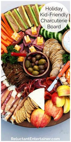 a platter filled with meats, cheeses, and fruits on top of a table