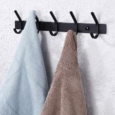 two towels are hanging on a towel rack