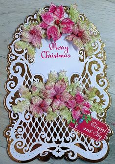 a christmas card with pink flowers on it and a merry message in the center that reads,