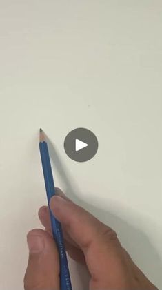 a person holding a pencil in their left hand