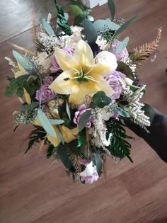 a bridal bouquet with yellow and purple flowers