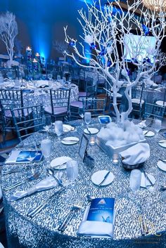 the table is set with silver linens and place settings