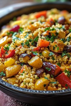 a bowl filled with rice and vegetables on top of a table