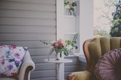 two chairs and a table with flowers on them