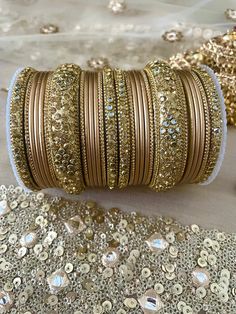 Indian Bangles Jewellery Metal Broad Kangan Karwachauth Navrati Bollywood Weddings Eid Diwali Parties. ⭐️ We often put videos and more images of these items on our Instagram page, please have a look  https://www.instagram.com/tohfaa_london/ Sizes - 2.4/2.6/2.8/2.10 2.4 is 2.25 inches 2.6 is 2.37 inches 2.8 is 2.5 inches 2.10 is 2.62 inches Other designs available please check my other listings! Material - Metal, Kundan, Rhinestone. Metallic finish bangles Set is for two hands. 13 bangles in each Diwali Gold Sets With Gota Work, Festive Gold Sets For Navratri, Gold Gota Work Sets For Diwali, Diwali Gold Gota Work Sets, Gold Zari Work Sets For Festivals, Gold Sets With Pallu For Navratri, Gold Sets With Pallu For Festivals, Gold Sets With Pallu Detail For Festivals, Traditional Gold Sets For Festive Occasions