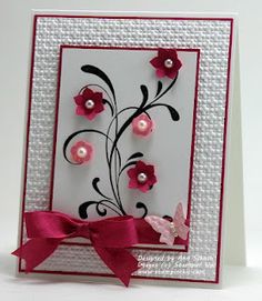 a white card with pink flowers on it