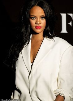 a woman with long black hair wearing a white suit and red lipstick on her lips