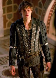 the young man is dressed in medieval clothing